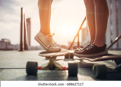 Young woman is posing with skateboard in the city. Female outdoor with long board. - Shutterstock ID 688627117