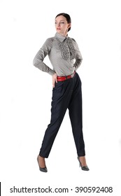 Young woman posing in strict trousers and shirt. White background.