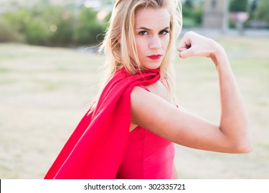 Young woman posing as superhero or wonderwoman