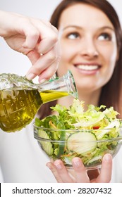 Young Woman Pouring Olive Oil Close Up