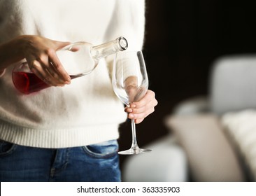 Young woman pouring pink wine into glass on blurred background - Shutterstock ID 363335903