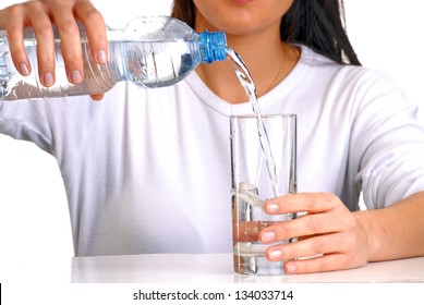 Young Woman Pouring Potable Water On A Glass.