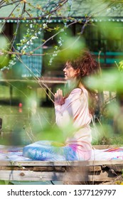 Young Woman Practice Yoga Outdoor Spring Summer  Day By The Lake Sit In Lotus Position With Hands In Anjali Mudra