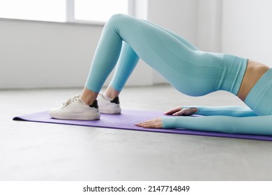 Young Woman Practicing Abdominal Knee Crunches For Upper And Lower Abs Exercise Working Out, Wearing Black Sportswear At Gym