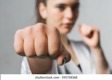 Young Woman Practicing with Karate Martial Art - Shutterstock ID 595758368