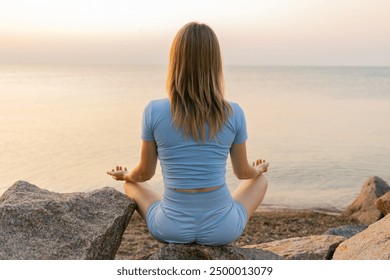 Young woman practicing morning meditation in nature at the beach. - Powered by Shutterstock