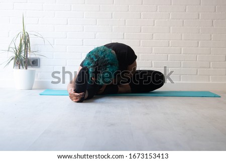 young woman practicing sport at home or gym doing exercises or stretching