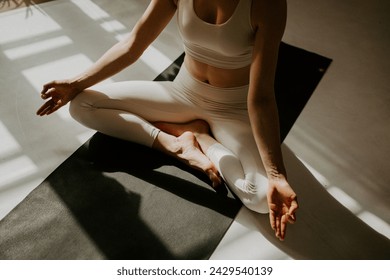 Young woman practicing yoga, doing Push ups exercise, chaturanga dandasana pose, working out, wearing sportswear, indoor, beautiful yoga studio - Powered by Shutterstock