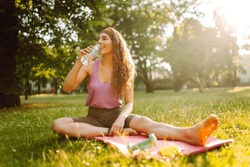 Young Woman Practicing Yoga During Workout In Park. Fitness. Active Lifestyle.