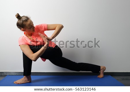 Young woman practicing yoga exercise, deep lunge for flexibility and health
