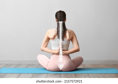Young woman practicing yoga in gym. Concept of healthy spine - Shutterstock ID 2157572921