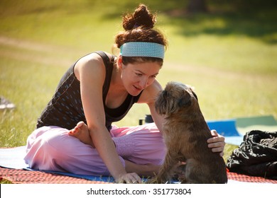 Young Woman Is Practicing Yoga With Her Dog