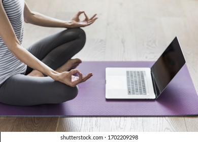 Young Woman Practicing Yoga At Home. Online Video Training. Girl Doing Exercises And Meditate. Yoga, Balance, Meditation, Relaxation At Home, Healthy Lifestyle, Online Training Class Concept.