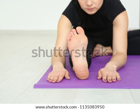 Young woman practicing yoga indoors