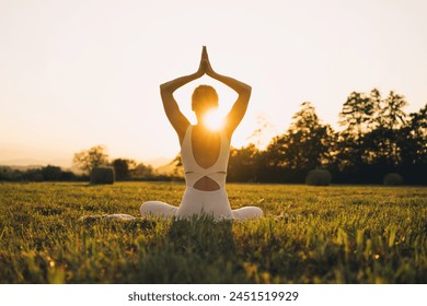 Young woman practicing yoga on nature. Girl meditating outdoors. Female with slim, strength and flexibility body. Healthy lifestyles. Concept of vitality, calmness, relax, mindfulness, zen energy. - Powered by Shutterstock