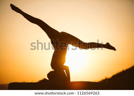 Similar – Two sisters doing gymnastics at sunset