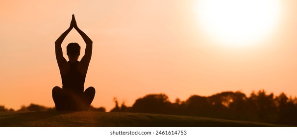 Young woman practicing yoga outdoors in the morning - Powered by Shutterstock