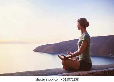Young woman practicing yoga outdoors. Harmony and meditation concept. Healthy lifestyle