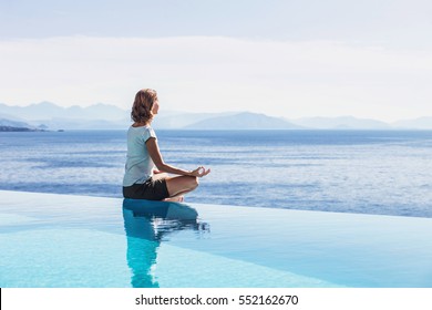 Young woman practicing yoga outdoors. Relaxation harmony lifestyle concept - Powered by Shutterstock