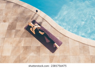 Young woman practicing yoga at the poolside in the evening. High quality photo - Powered by Shutterstock