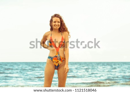 Similar – Brunette surfer woman in bikini standing with surfboard