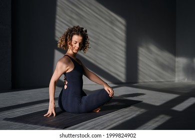 Young woman practicing yoga poses in an urban background on sunny day - Powered by Shutterstock