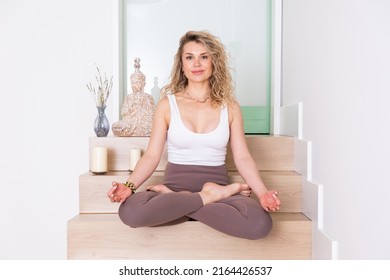 Young Woman Practicing Yoga Poses, Yoga Teacher Sitting In Lotus Position Meditating In Studio Portrait