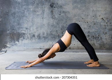 Young woman practicing yoga in a urban background
