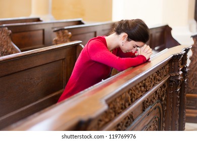 Young Woman Praying In A Church