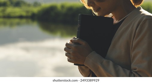 Young woman praying to god with the bible, Christianity, Concept of faith for god and teachings from the Bible.