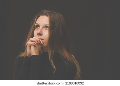Young woman praying  to God. Christian life crisis prayer to god. - Shutterstock ID 2108010032