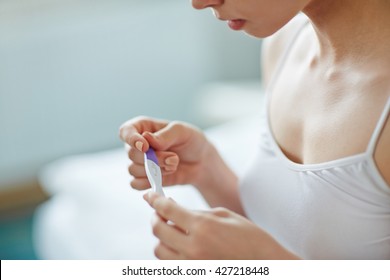 Young woman with pregnancy test in hands