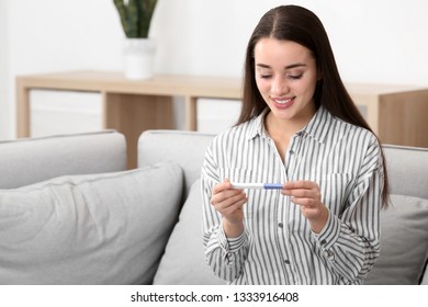 Young woman with pregnancy test at home. Gynecology and childbirth - Shutterstock ID 1333916408