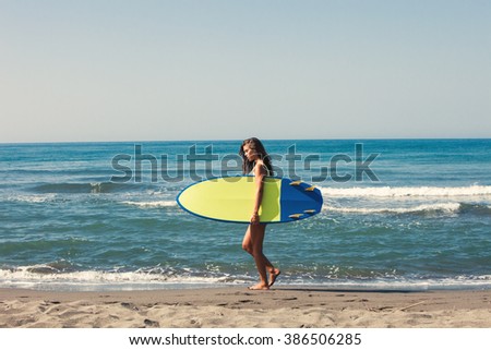 Similar – Young surfer woman with top and bikini holding surfboard