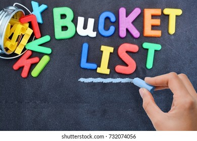 Young Woman Prepared For Bucket List With Metallic Bucket And Colorful Plastic Letters On Blackboard 