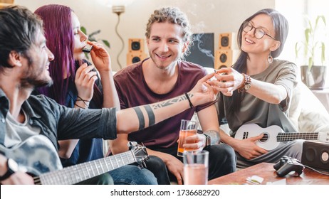 Young Woman Preparing To Smoke Joint With Cannabis While Relaxing With Friends At Home