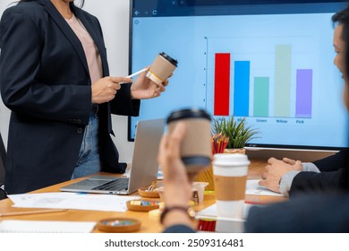 The young woman is presenting a product sample in the meeting - Powered by Shutterstock