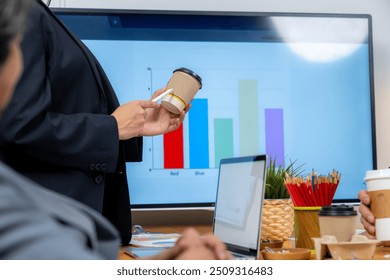 The young woman is presenting a product sample in the meeting - Powered by Shutterstock