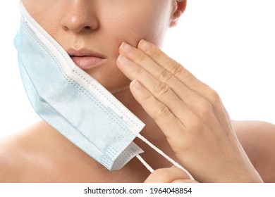 Young Woman With Prevention Mask And Skin Irritation On White Background. Maskne - Acne Breakouts From Wearing A Face Mask.