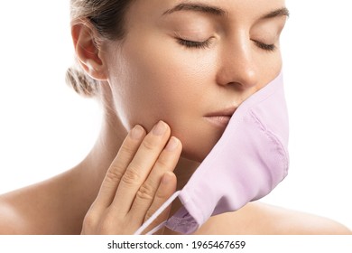 Young Woman With Prevention Mask And Skin Irritation On White Background. Maskne - Acne Breakouts From Wearing A Face Mask.