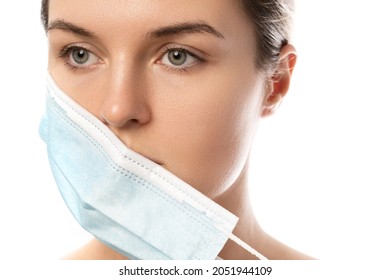 Young Woman With Prevention Mask And Skin Irritation On White Background. Maskne - Acne Breakouts From Wearing A Face Mask.