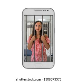 Young Woman Prisoner In Jail Of Cell Phone. Concept Of Dependence On Mobile Devices.