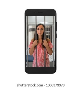 Young Woman Prisoner In Jail Of Cell Phone. Concept Of Dependence On Mobile Devices.