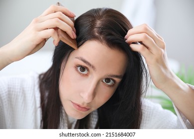 Young Woman With Problem Of Dandruff At Home