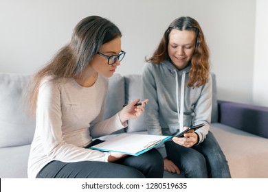 Young Woman Professional Psychotherapist Talking With Teen Girl In Office. Mental Health Of Child In Adolescence.