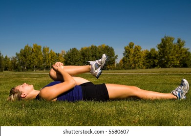 Young Woman In A Prone Hamstring Stretch.