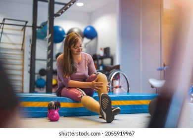 Young woman with prosthetic legs exercising at physiotherapy center
 - Powered by Shutterstock