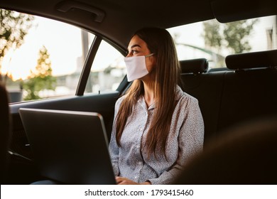 Young Woman With Protective Mask Working In A Car