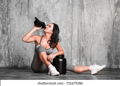 Young Woman With Protein Shake Bottle