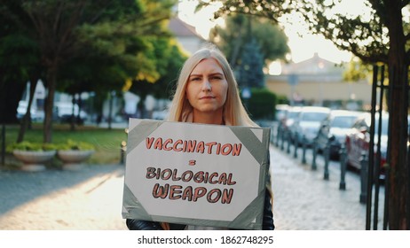 Young Woman Protesting Against Vaccination Like Biological Weapon. She Walking Down The Street